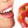 woman biting into apple